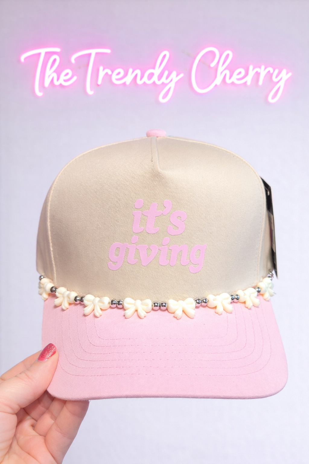 It's giving baby pink trucker hat with removable white bow hatching