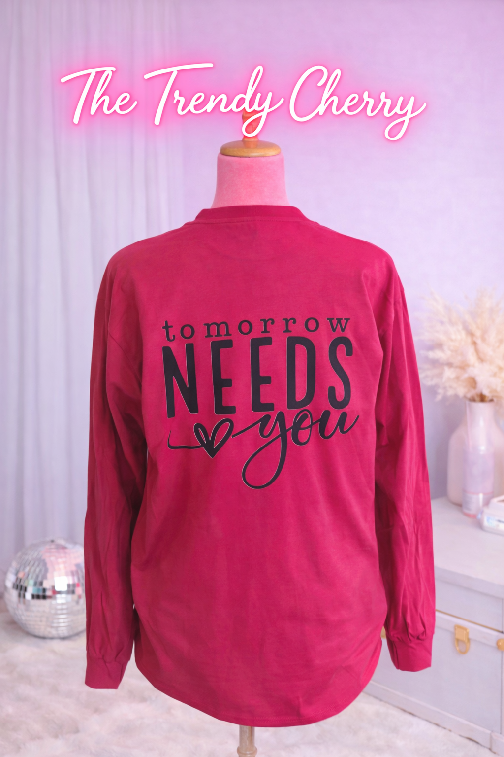 Tomorrow Needs You Maroon Long Sleeve printed on back. Front is plain