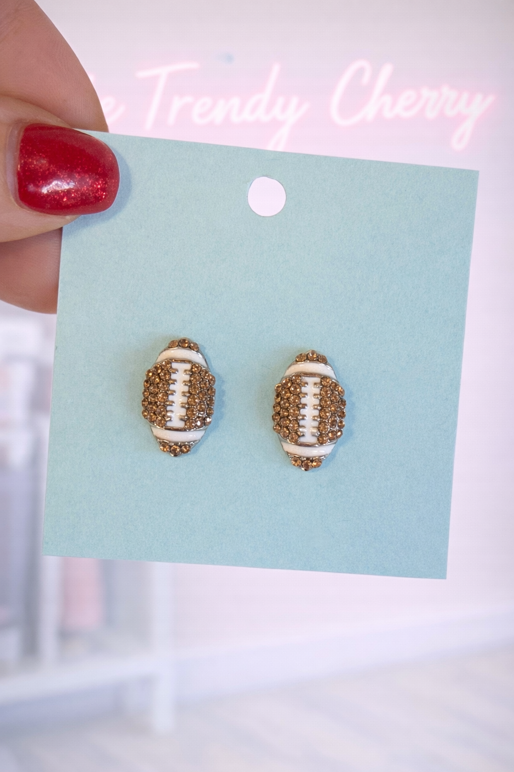 Glitzy football stud earrings